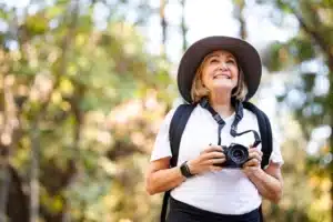 Senior woman enjoying bird watching hobby
