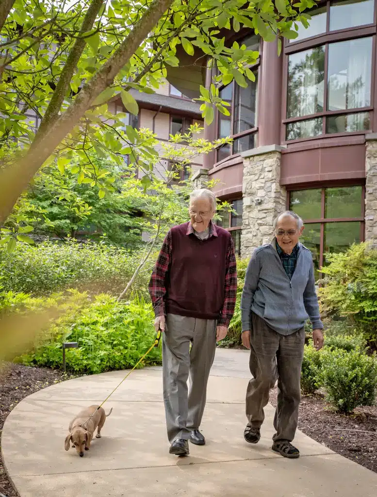 Men walking with dog at Fox Hill Residences
