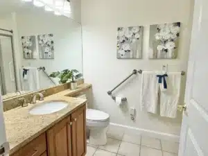 Bathroom in residence 648 with a granite vanity and framed artwork