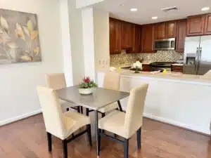 Kitchen in residence 648 with cherry cabinets opening onto a dining table