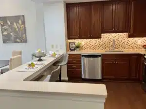 Kitchen breakfast bar in residence 648 with cherry cabinets and stainless appliances