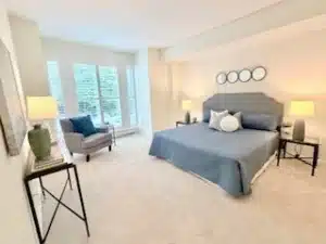 Condo Bedroom with a bed and large windows