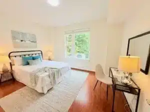condo bedroom with a desk and a bed