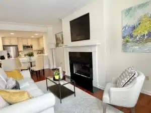 a condo with a living area and fireplace