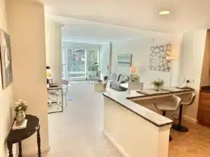 kitchen dining area and the living room of a condo